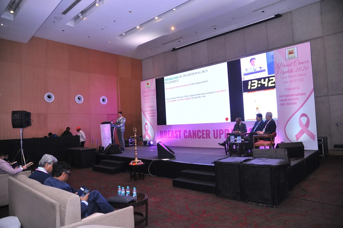 Qubix conference event with stage lighting and audience
